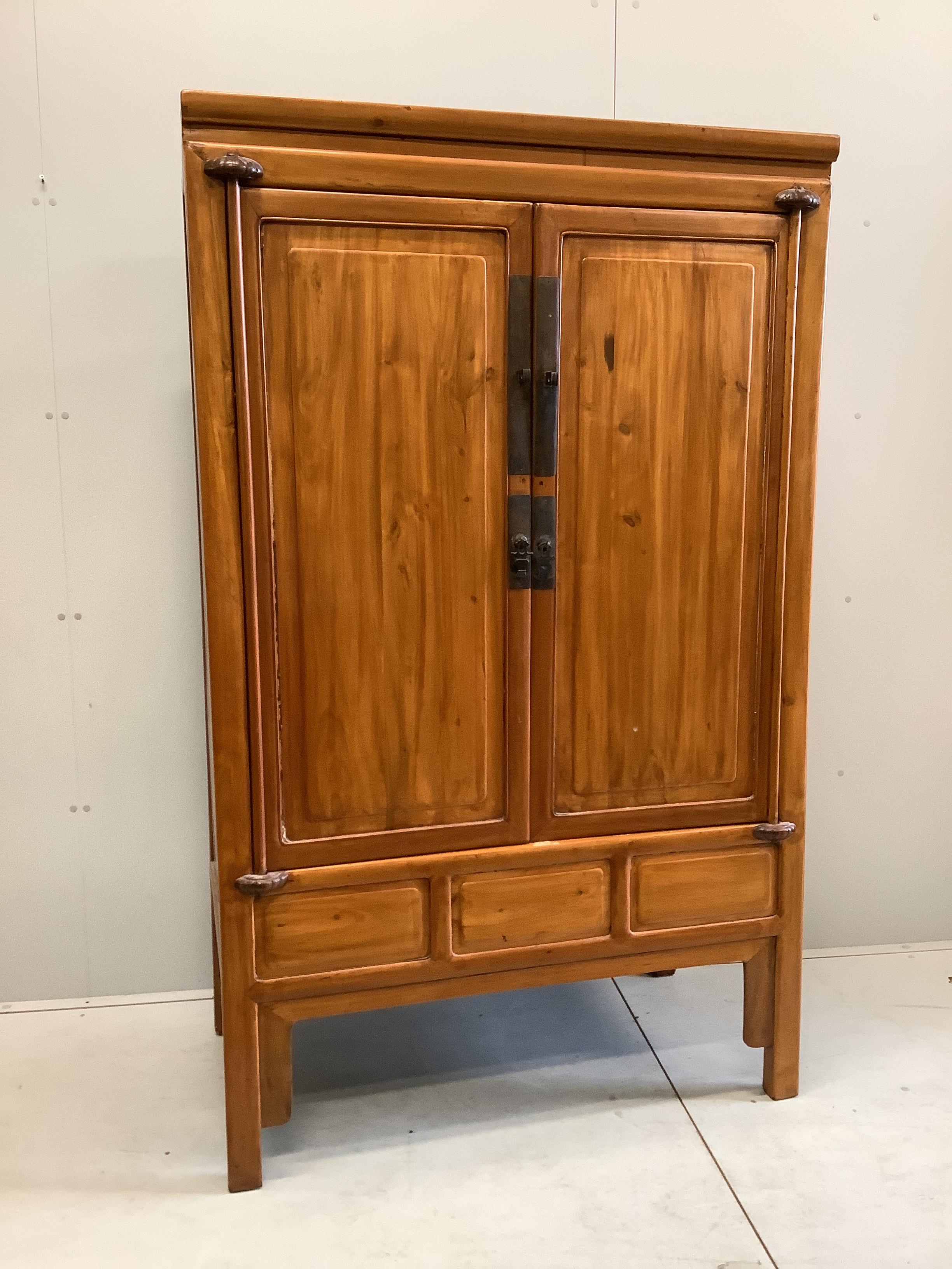 A Chinese elm cabinet, width 108cm, depth 60cm, height 177cm